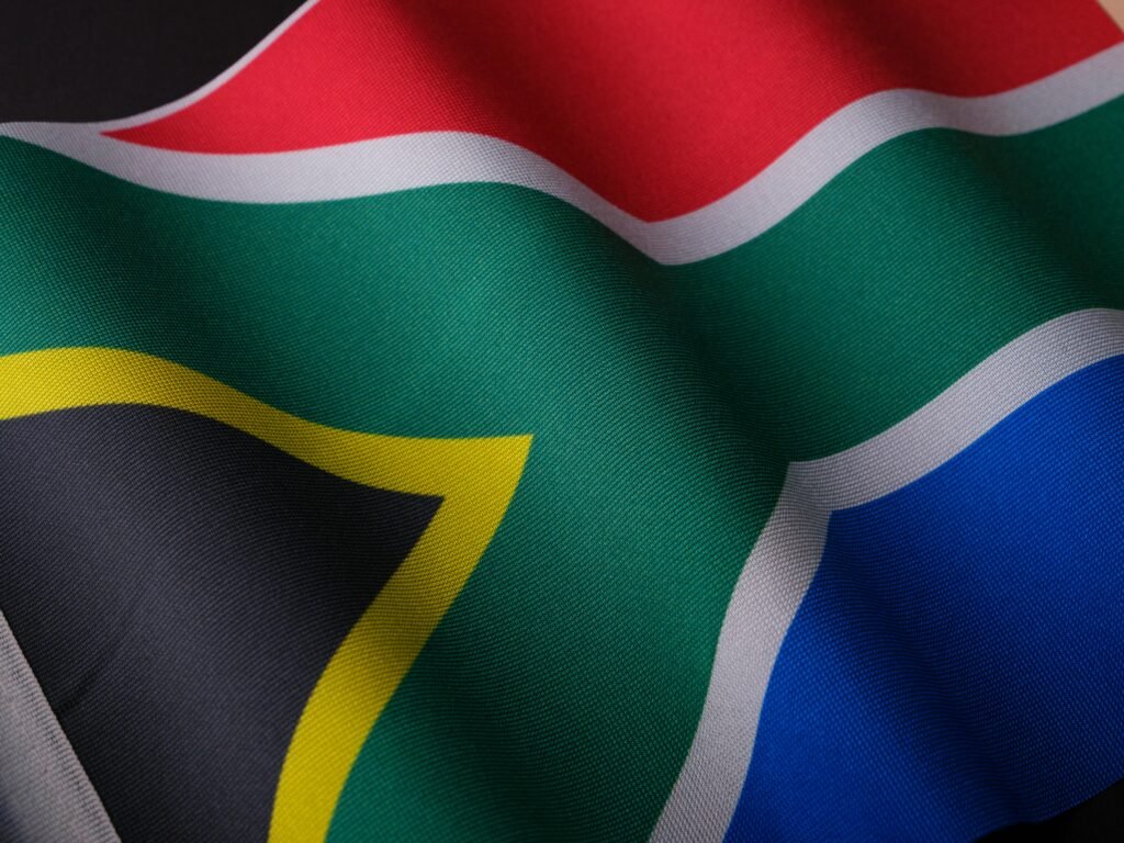 pexels-photo-16034039-16034039 Close-up of a waving South African flag showcasing its vibrant colors and detailed texture.